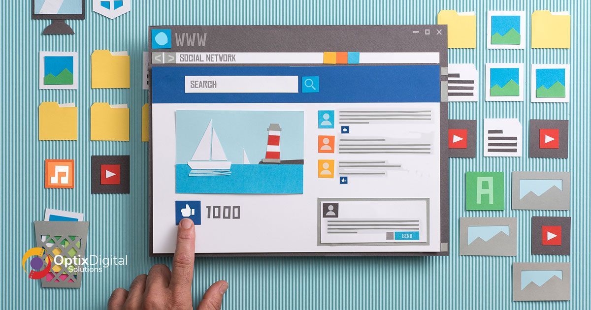 A person is pointing at a computer screen with a sailboat on it