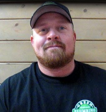 A man with a beard is wearing a hat and a black shirt.