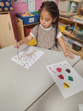 Infant Child Care — A Young Girl is Painting a Tree in Columbus, OH