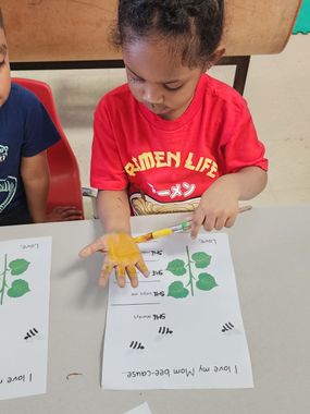 Childcare Columbus — A Young Girl is Coloring Her Hand Yellow in Columbus, OH