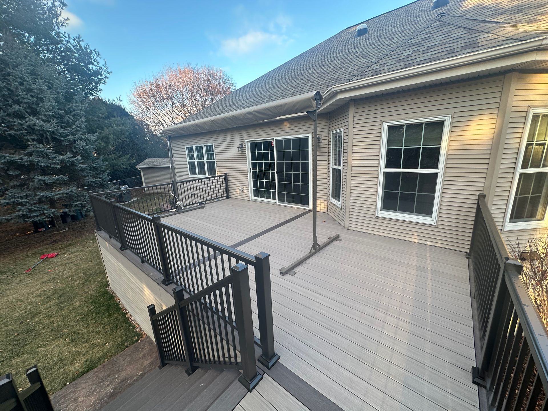 The back of a house with a large deck and stairs
