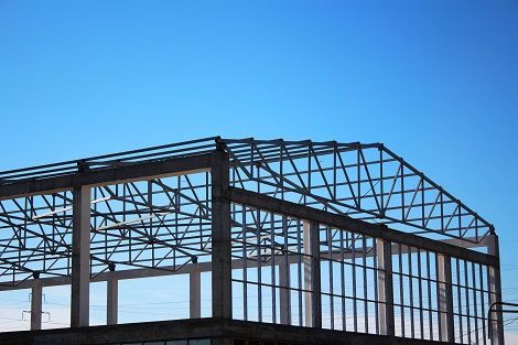 Metal building contractor assembling frame construction for custom metal buildings.
