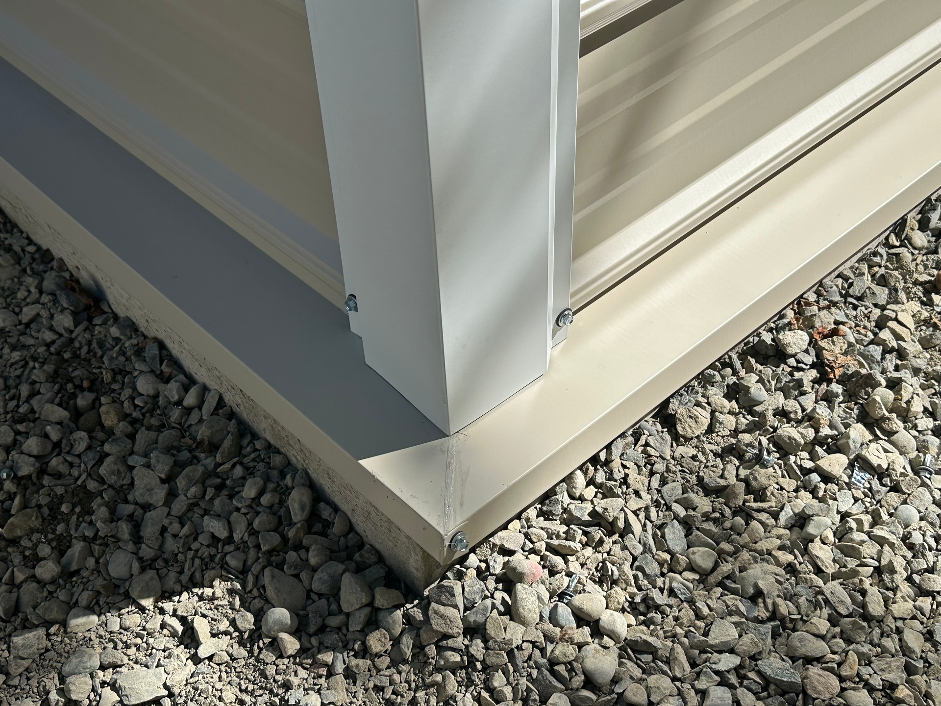 A red barn is in the middle of a grassy field