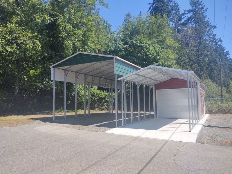 A laundry room with stainless steel appliances including a washer and dryer