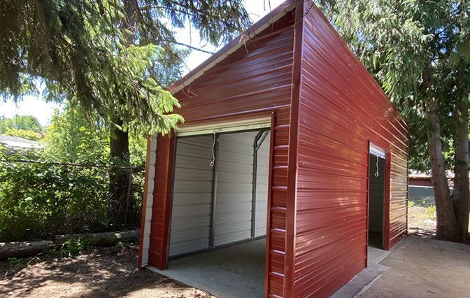 A red garage with a white door is in the backyard.