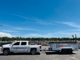 White pickup truck with a trailer labeled 