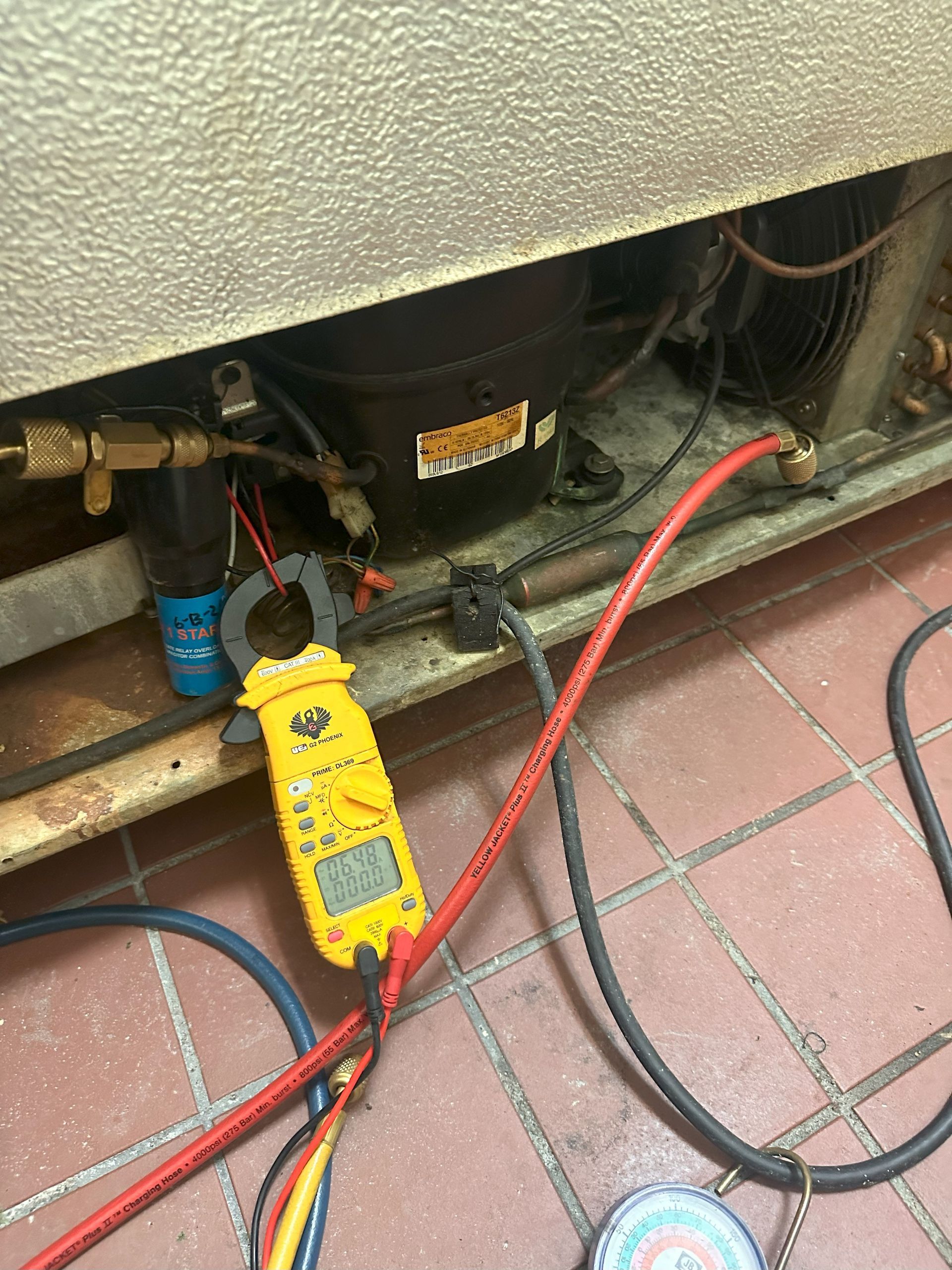 A clamp is being used to measure the temperature of a refrigerator.