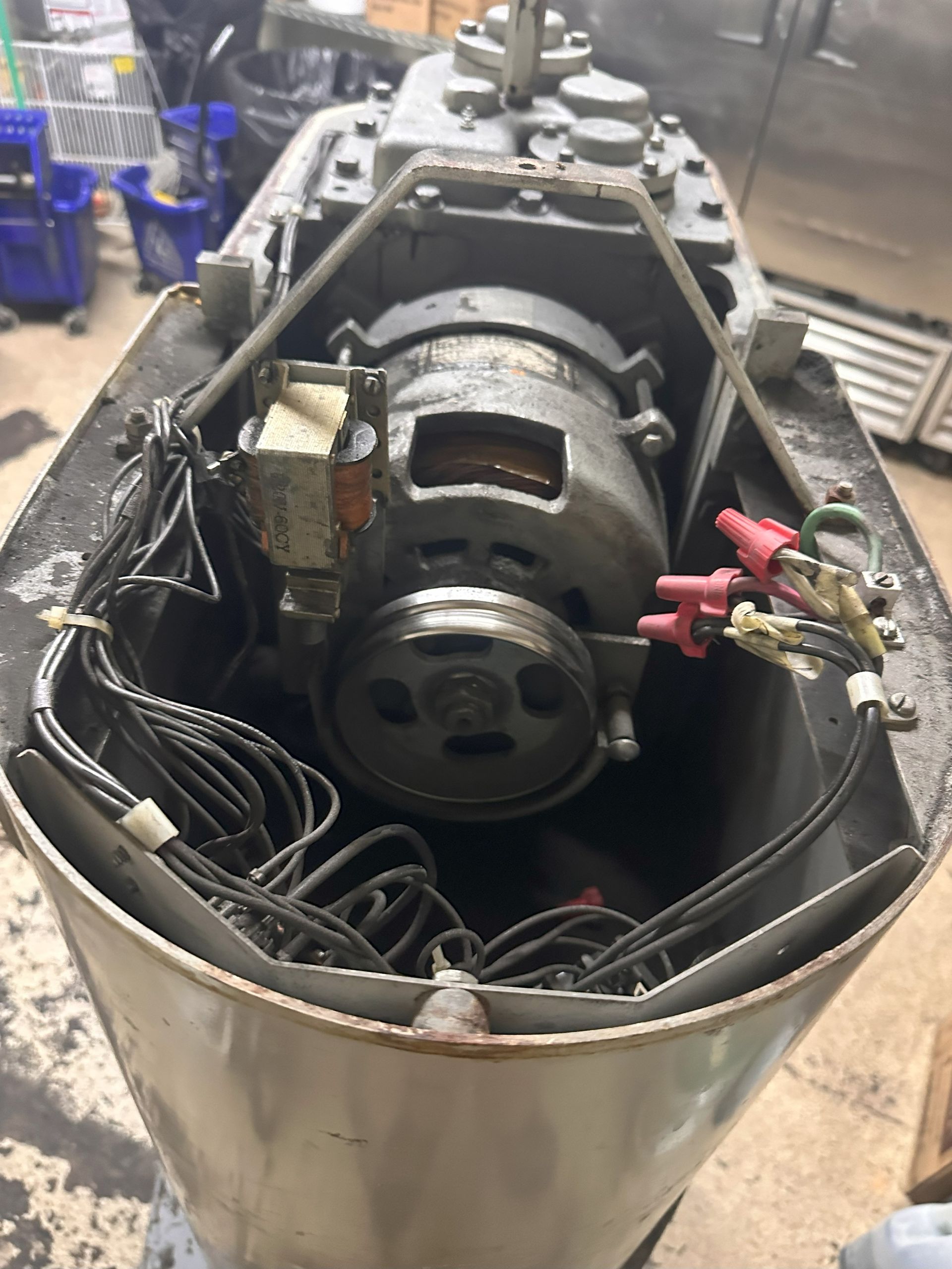 A motor is sitting inside of a boat in a garage.