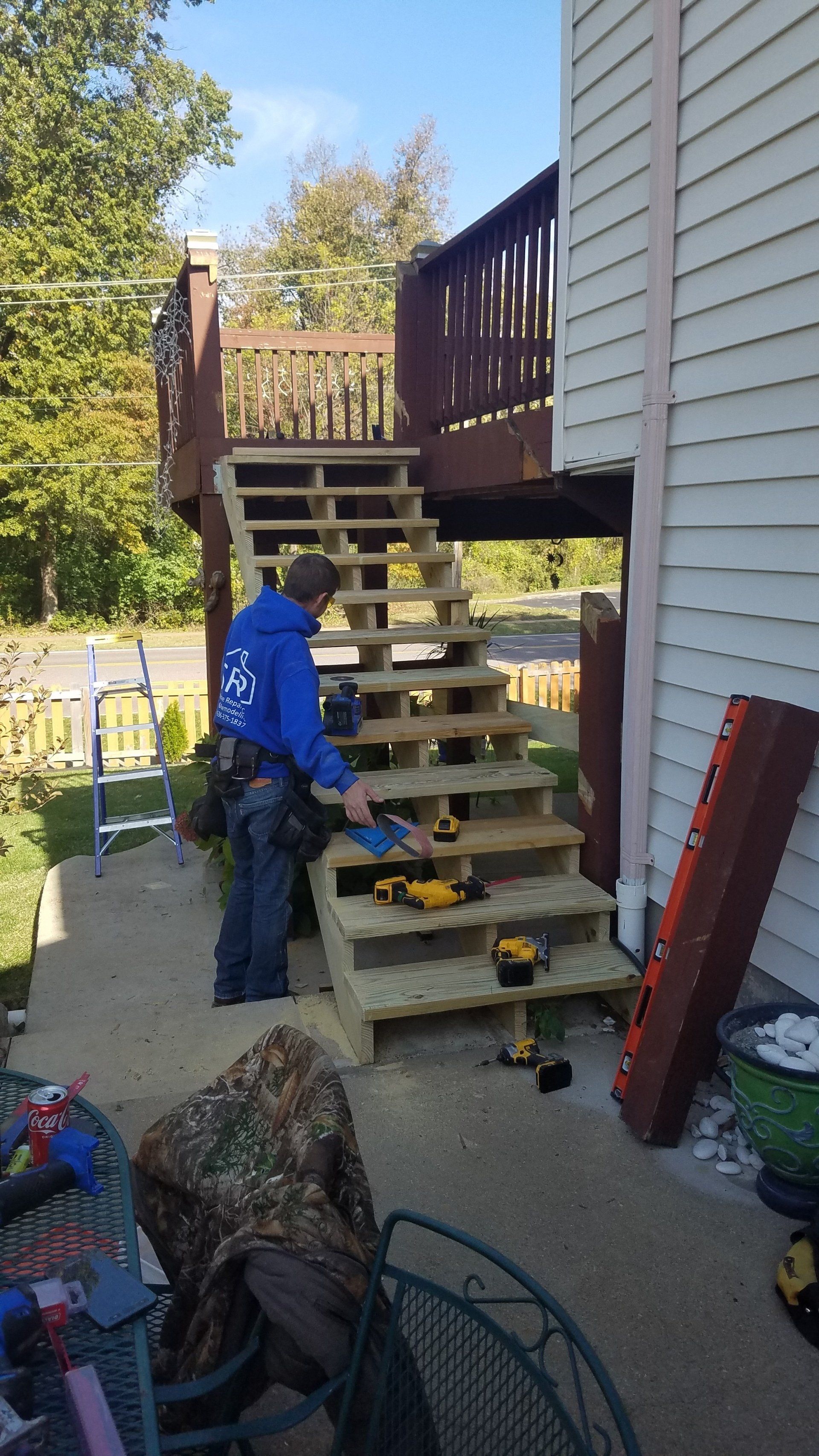 Worker next to stairs with power tools on it — Fenton, MO — SRP Home Improvement