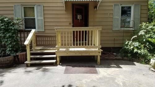 Nice small deck in front of door of beige house — Fenton, MO — SRP Home Improvement