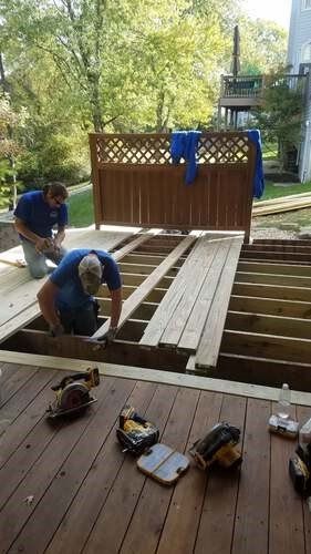 Multiple workers putting planks on deck being constructed — Fenton, MO — SRP Home Improvement