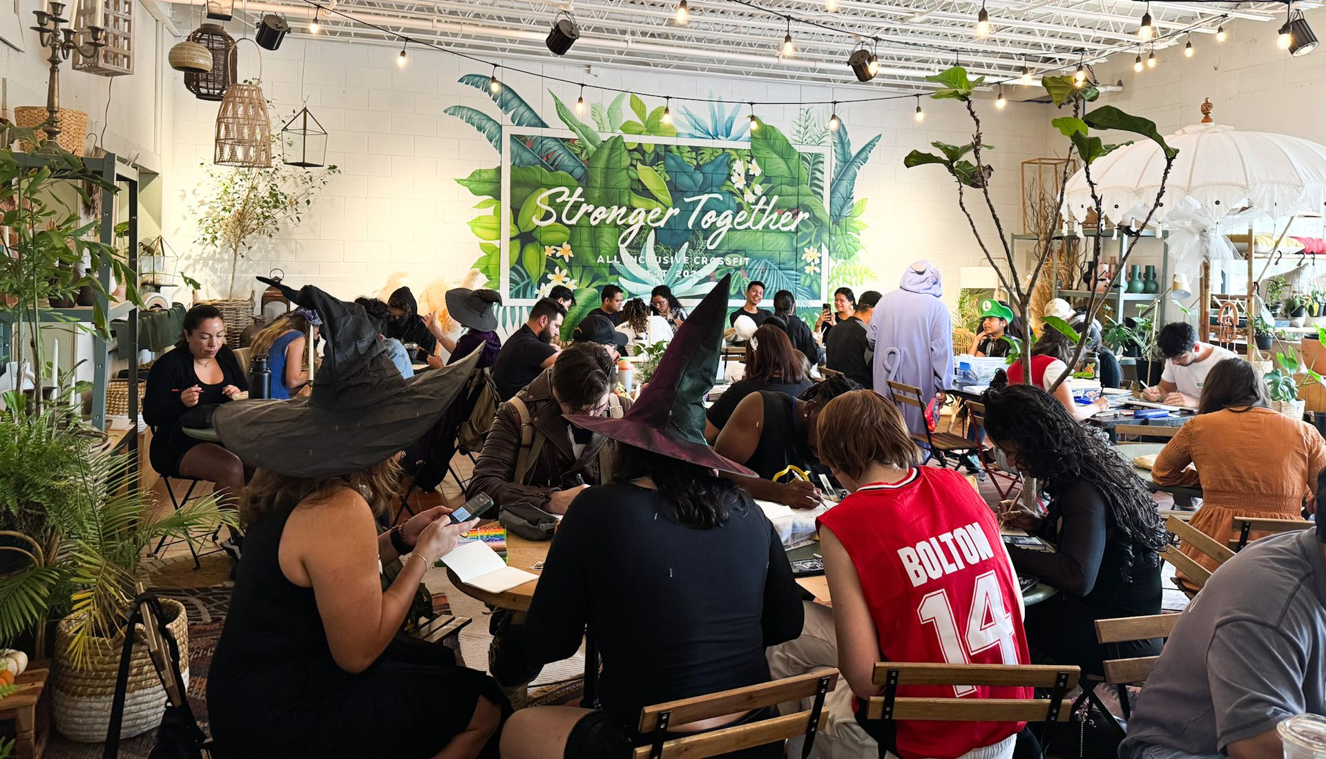 Guests at Harmon Collective in Winter Park enjoying a Halloween-themed Draw Lab event inside All Inclusive CrossFit, highlighting community, connection, and inclusive spaces