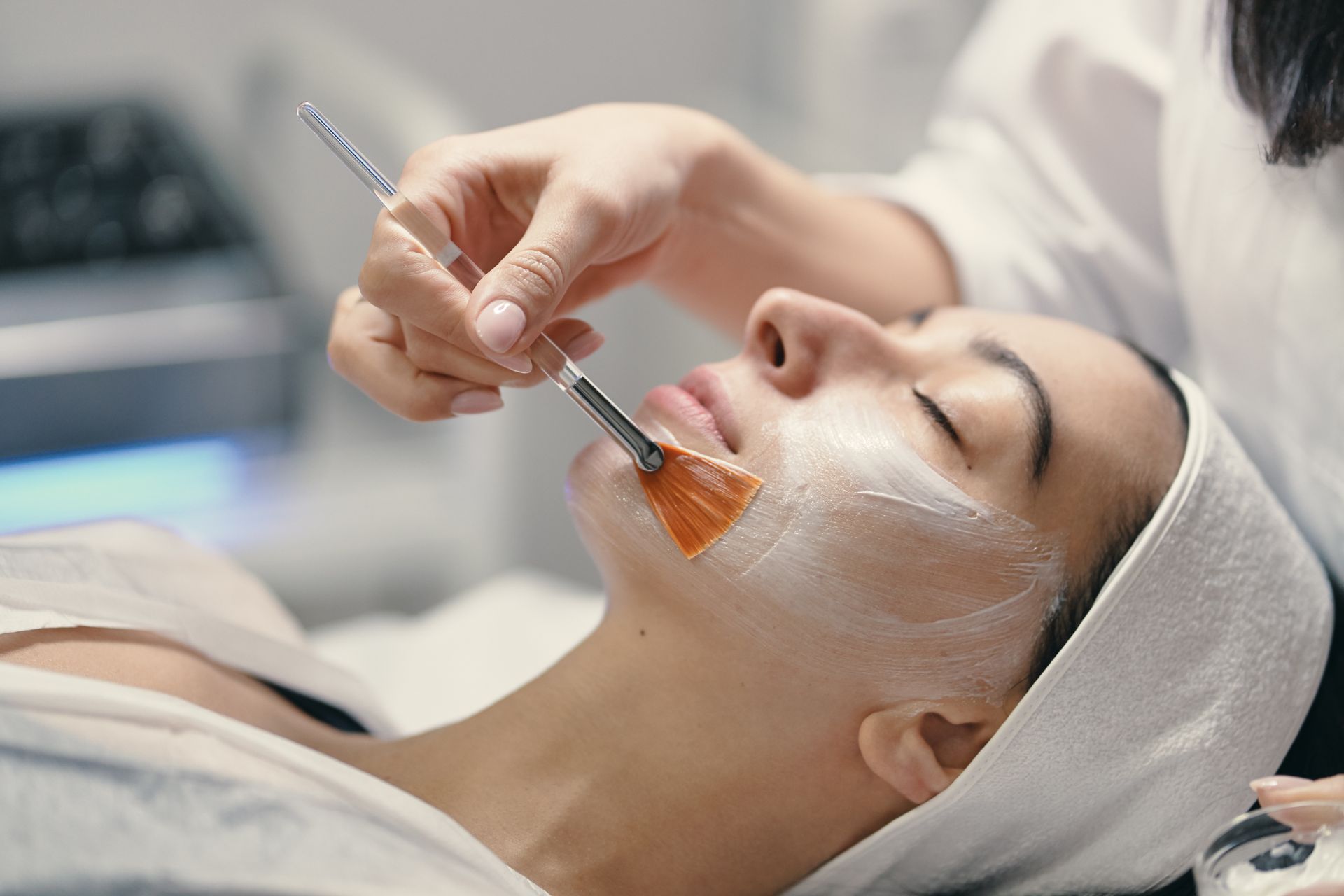 a woman is getting a facial treatment at a spa .