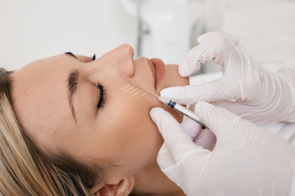 A woman is getting a botox injection in her face.