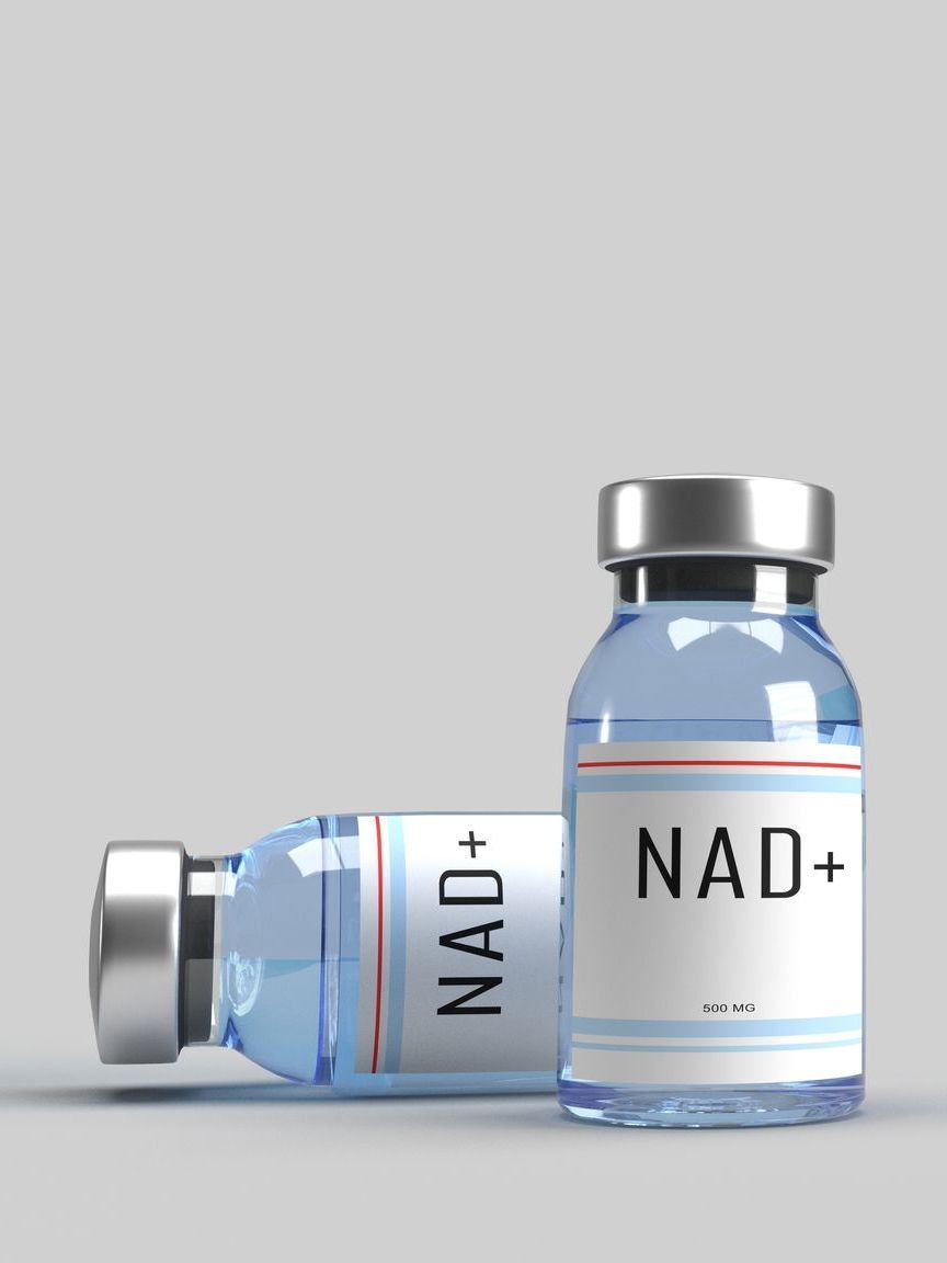 Two bottles of nad + are sitting next to each other on a table.