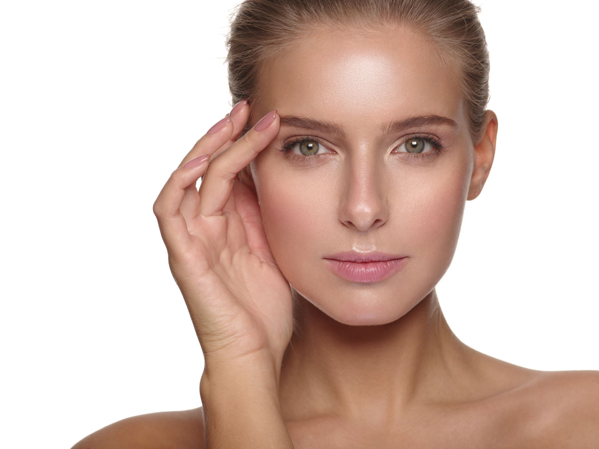 a close up of a woman 's face with her hand on her forehead .