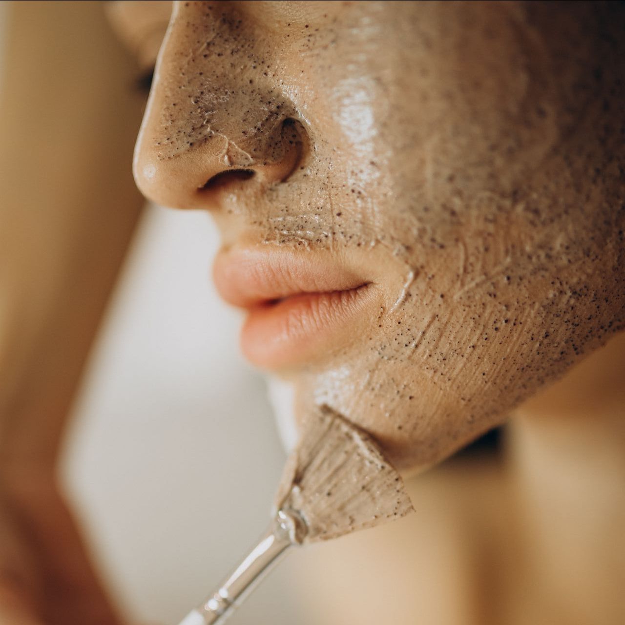 a woman is smiling while looking at her face in the mirror .