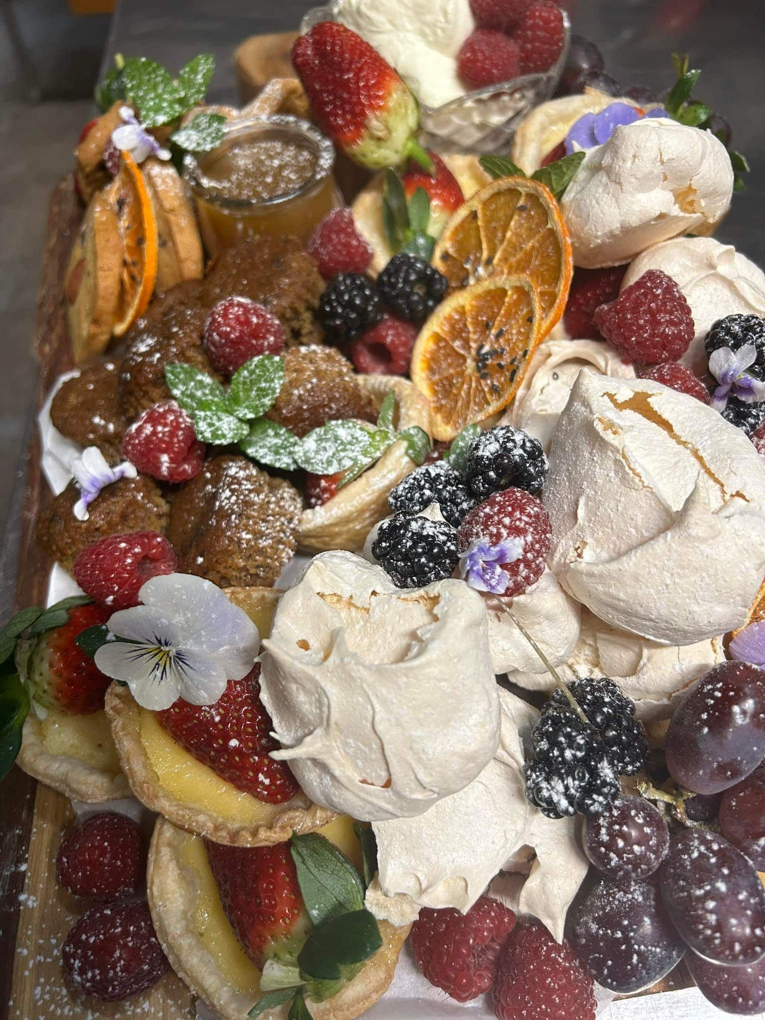 A dessert platter with tarts and fruit — Amanda Douglass Catering Service in Corlette, NSW