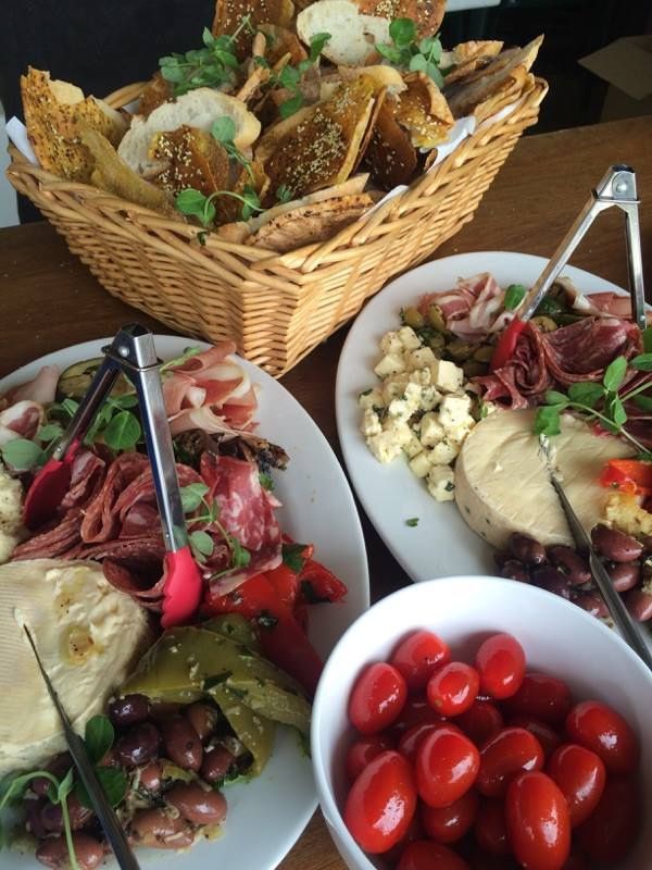 A table of cheeses and cherry tomatoes on the side — Amanda Douglass Catering Service in Corlette, NSW