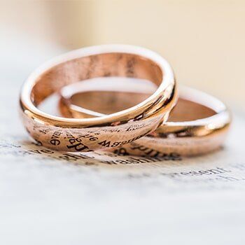 Gold Wedding Rings in a book — jewelry store in Santa Barbara, CA