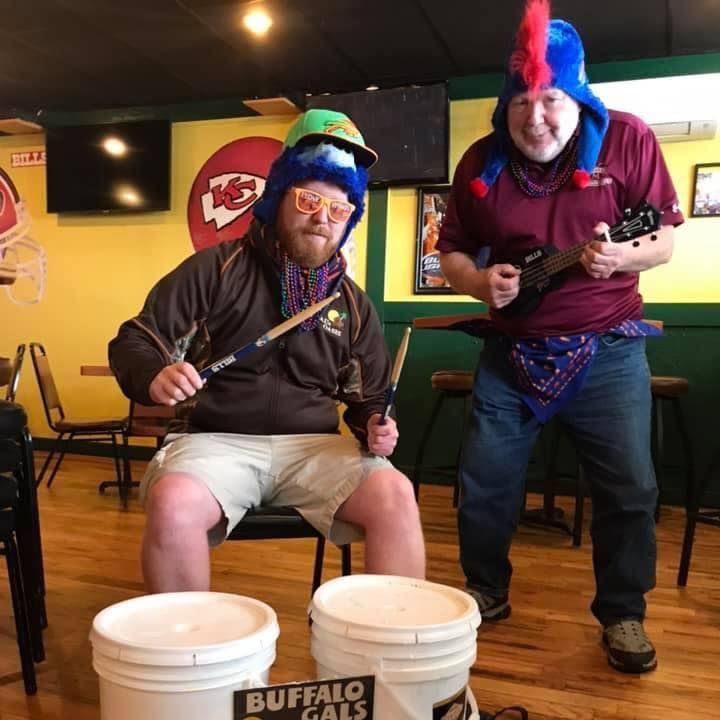 Two men are posing for a picture with buckets that say buffalo gals