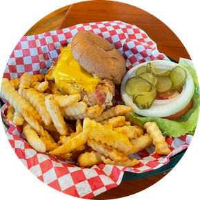 A hamburger and french fries in a basket on a checkered napkin.