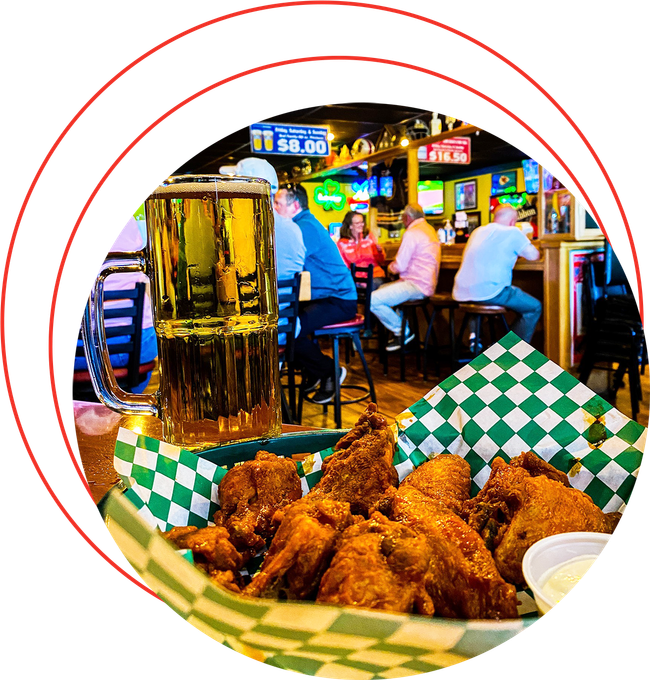 A basket of chicken wings sits on a table in a restaurant