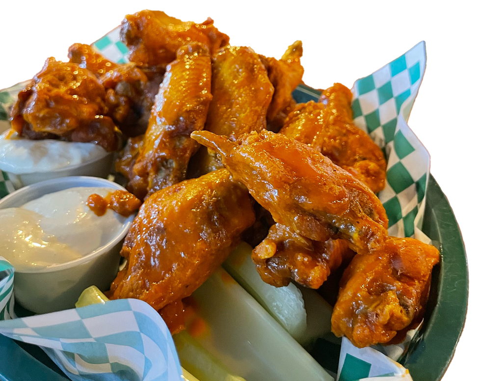 A basket of chicken wings with celery and dipping sauce