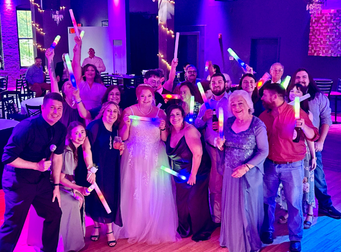 wedding guests smiling with DJ