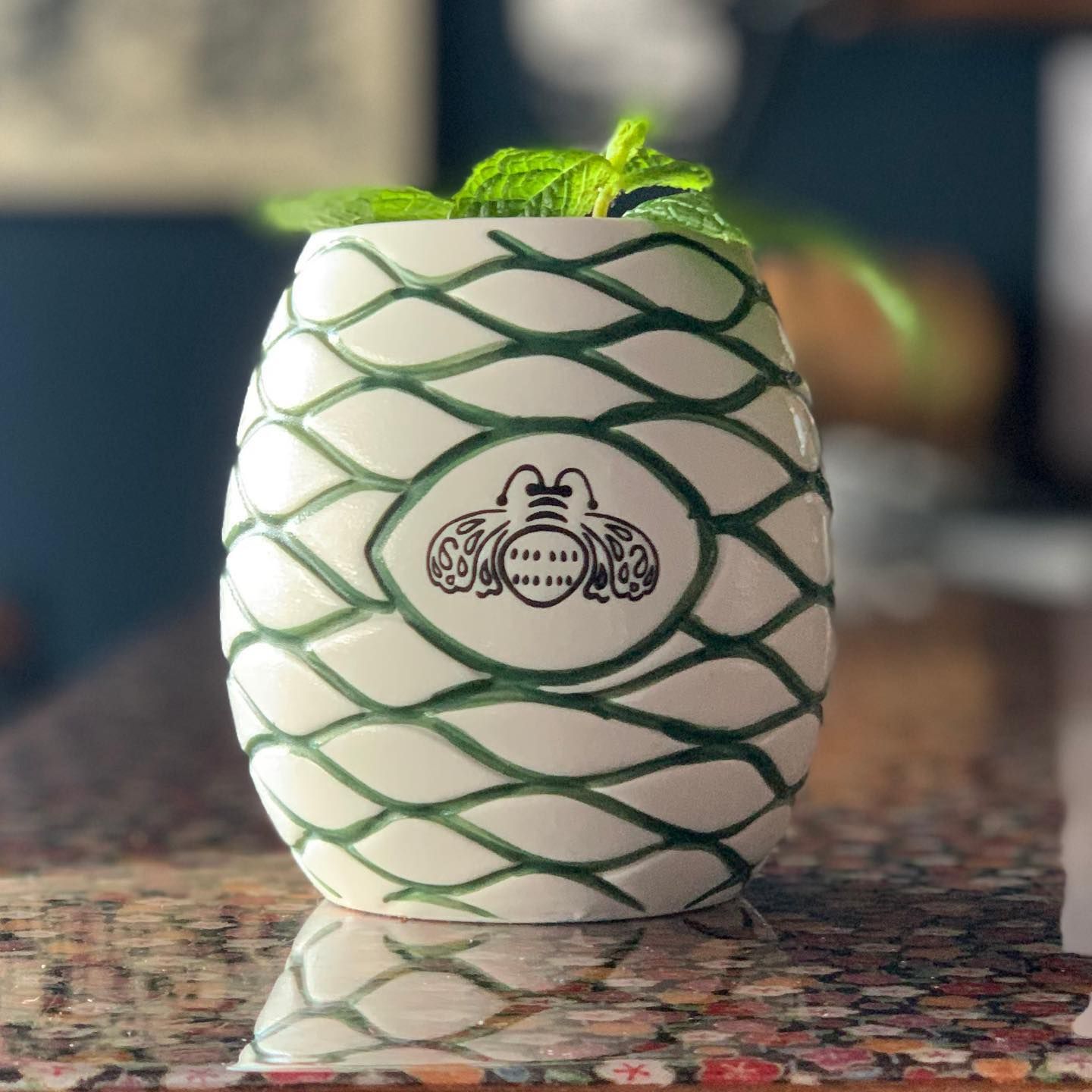 White and Green Pineapple-shaped Ceramic Cocktail Mug Filled With Mint Sprigs — Village Bicycle Noosa in Noosa Heads, QLD
