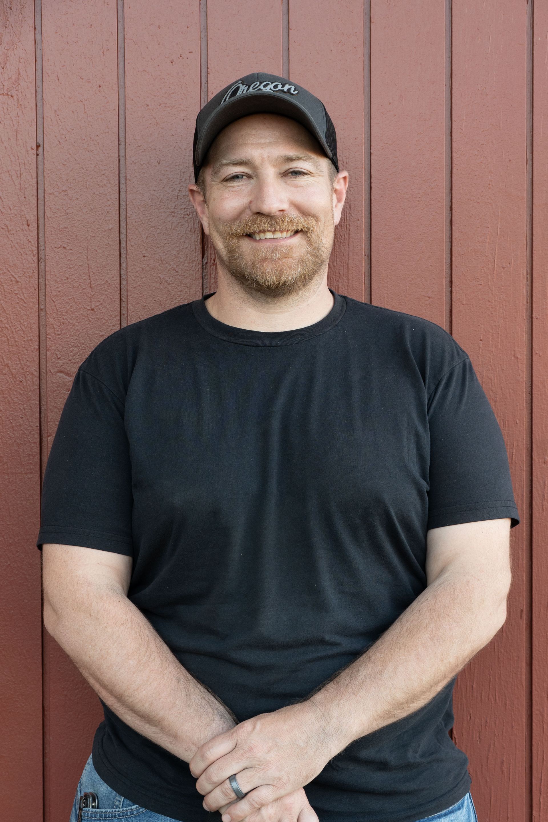 A sign that says `` coming soon '' next to a branch of eucalyptus leaves.