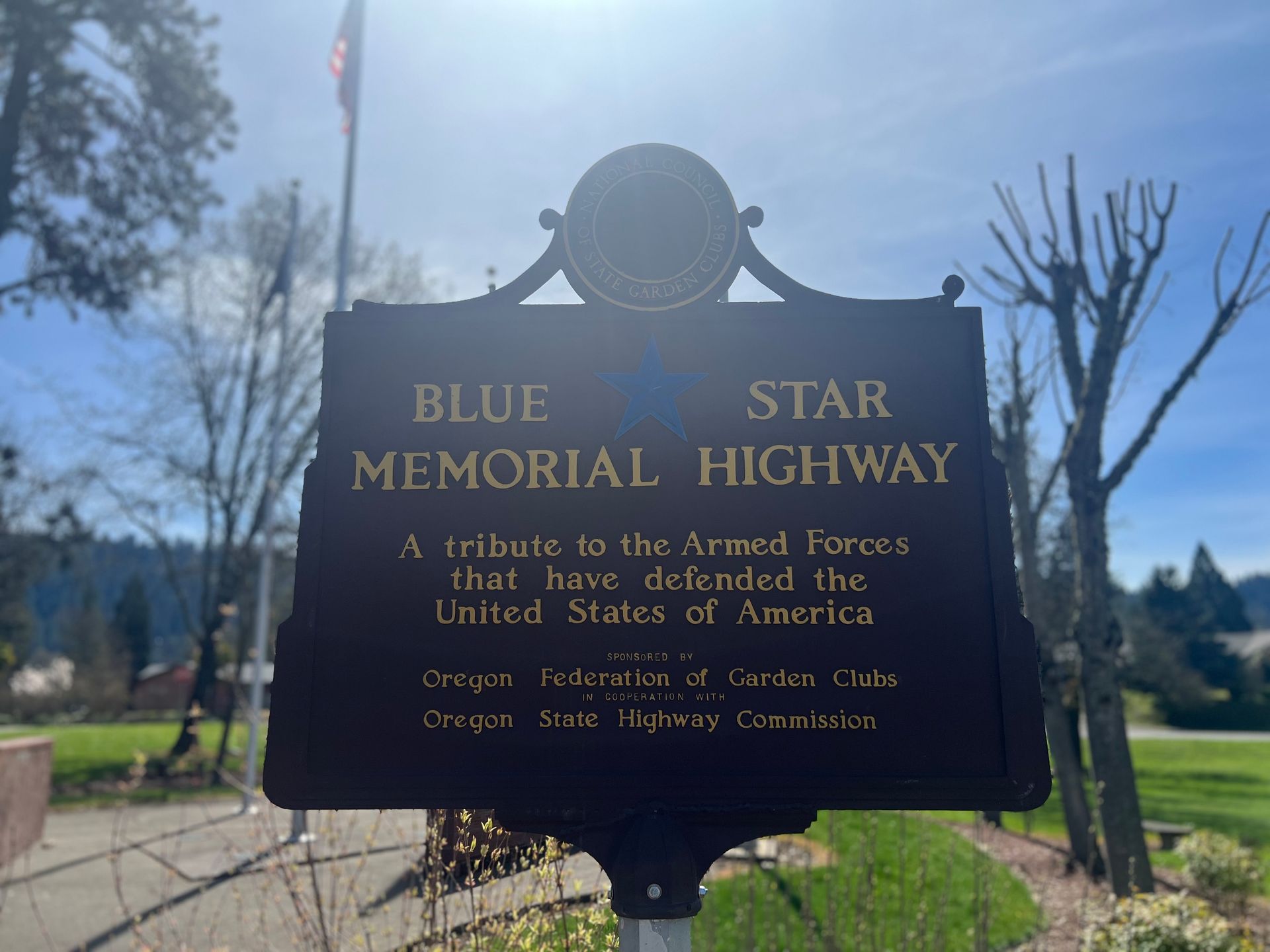 A black sign that says blue star memorial highway on it