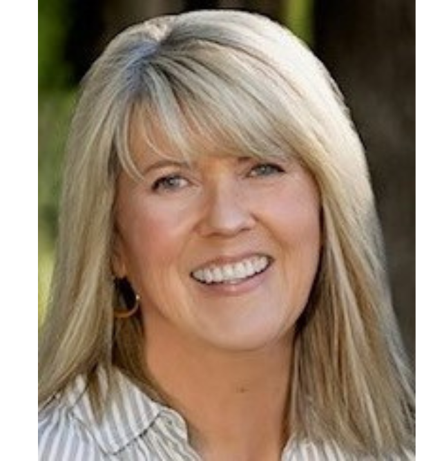 A woman with long blonde hair is smiling and wearing a striped shirt.