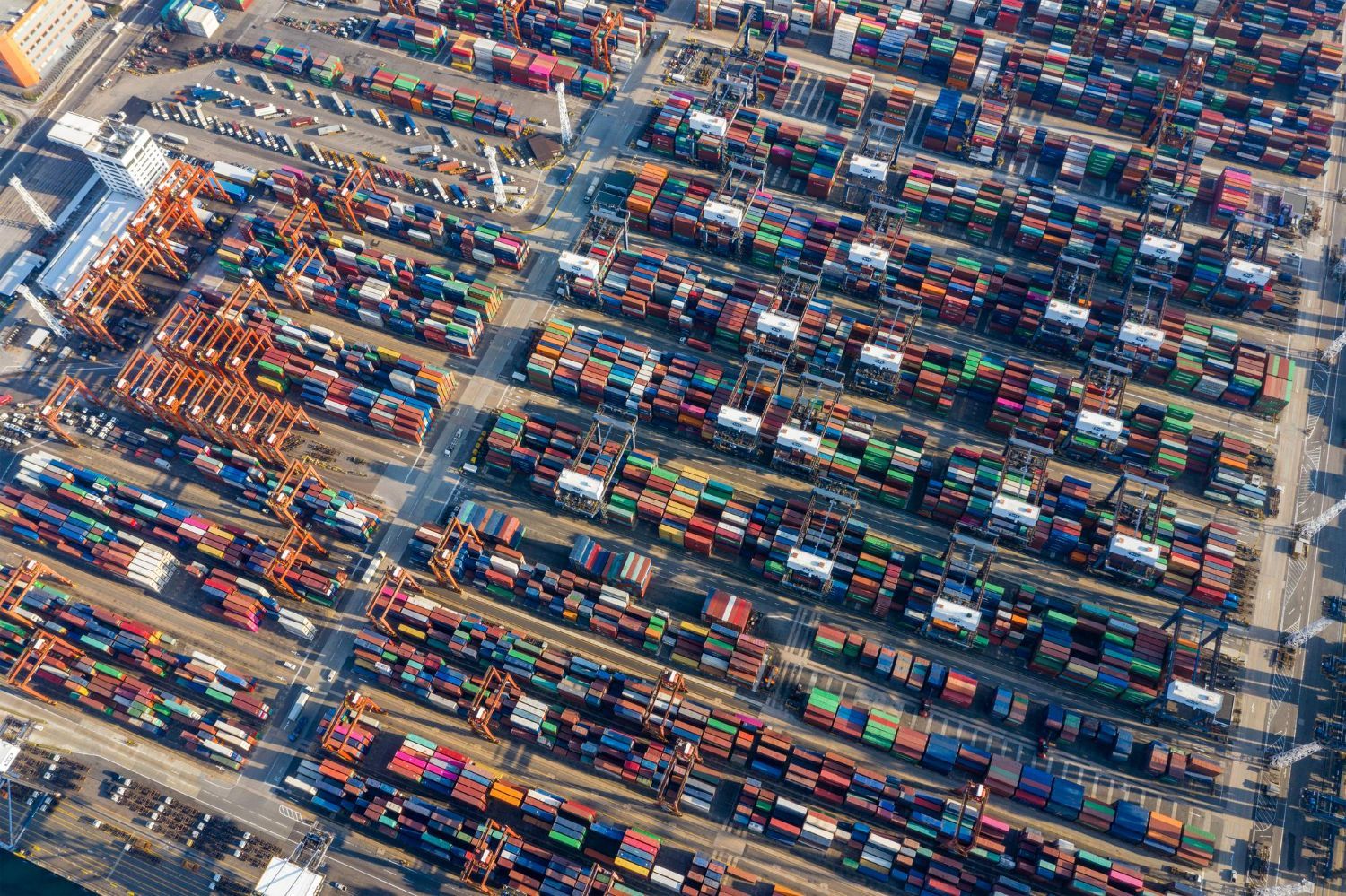 An aerial view of a large container port filled with lots of containers.