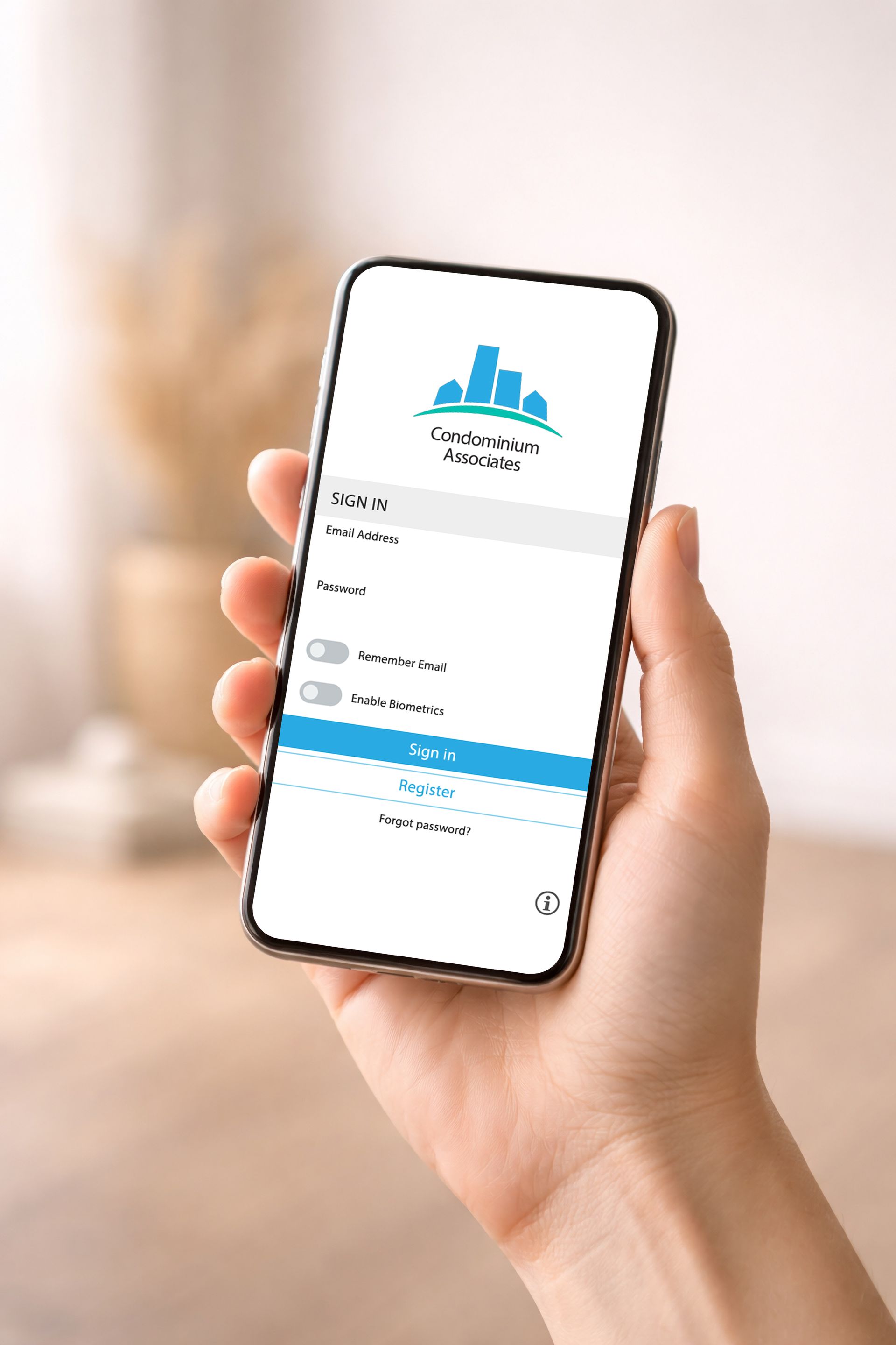 Hand holding a smartphone showing a blue-and-white app login screen