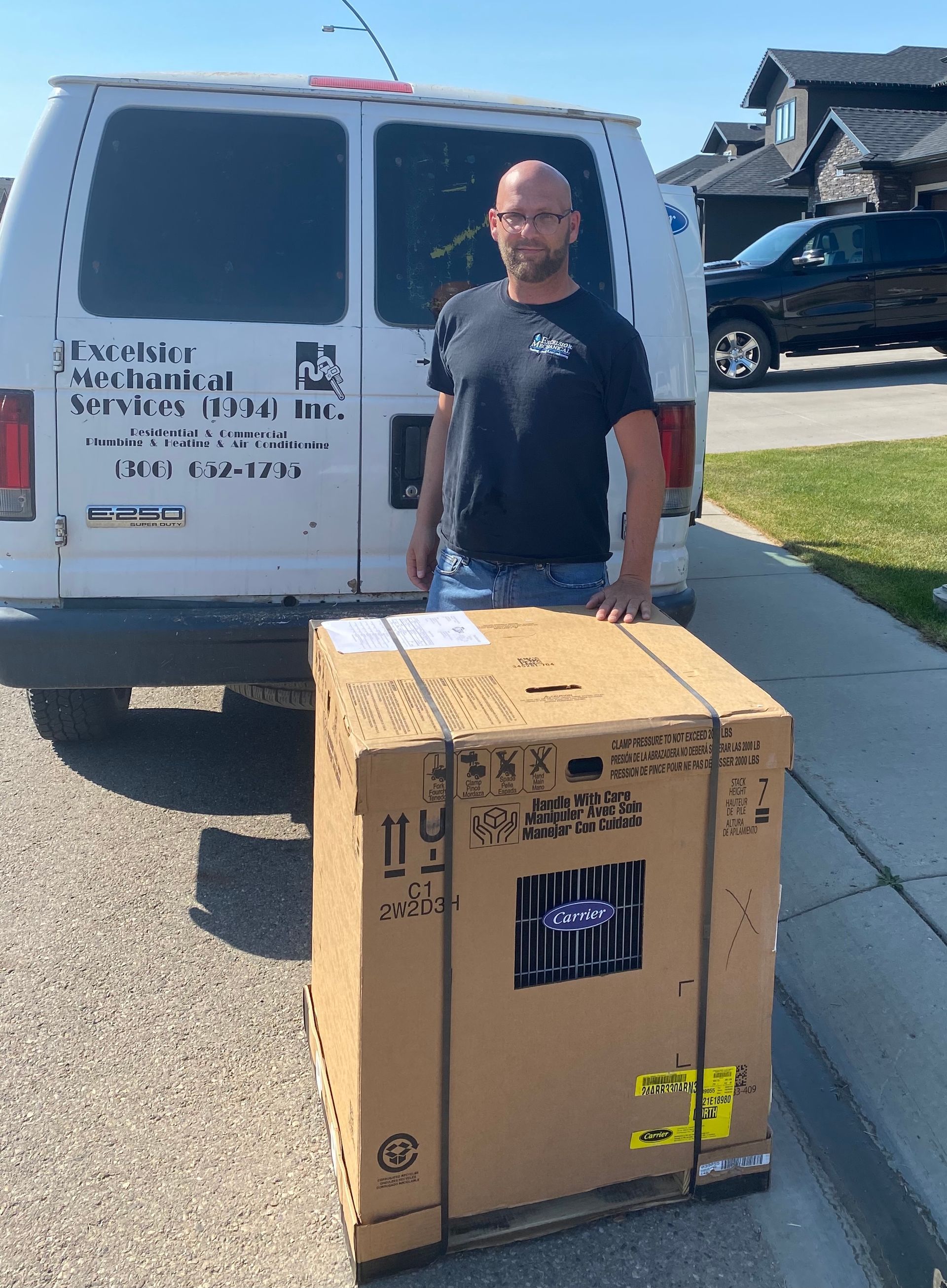 a man is standing next to a cardboard box in front of a van .