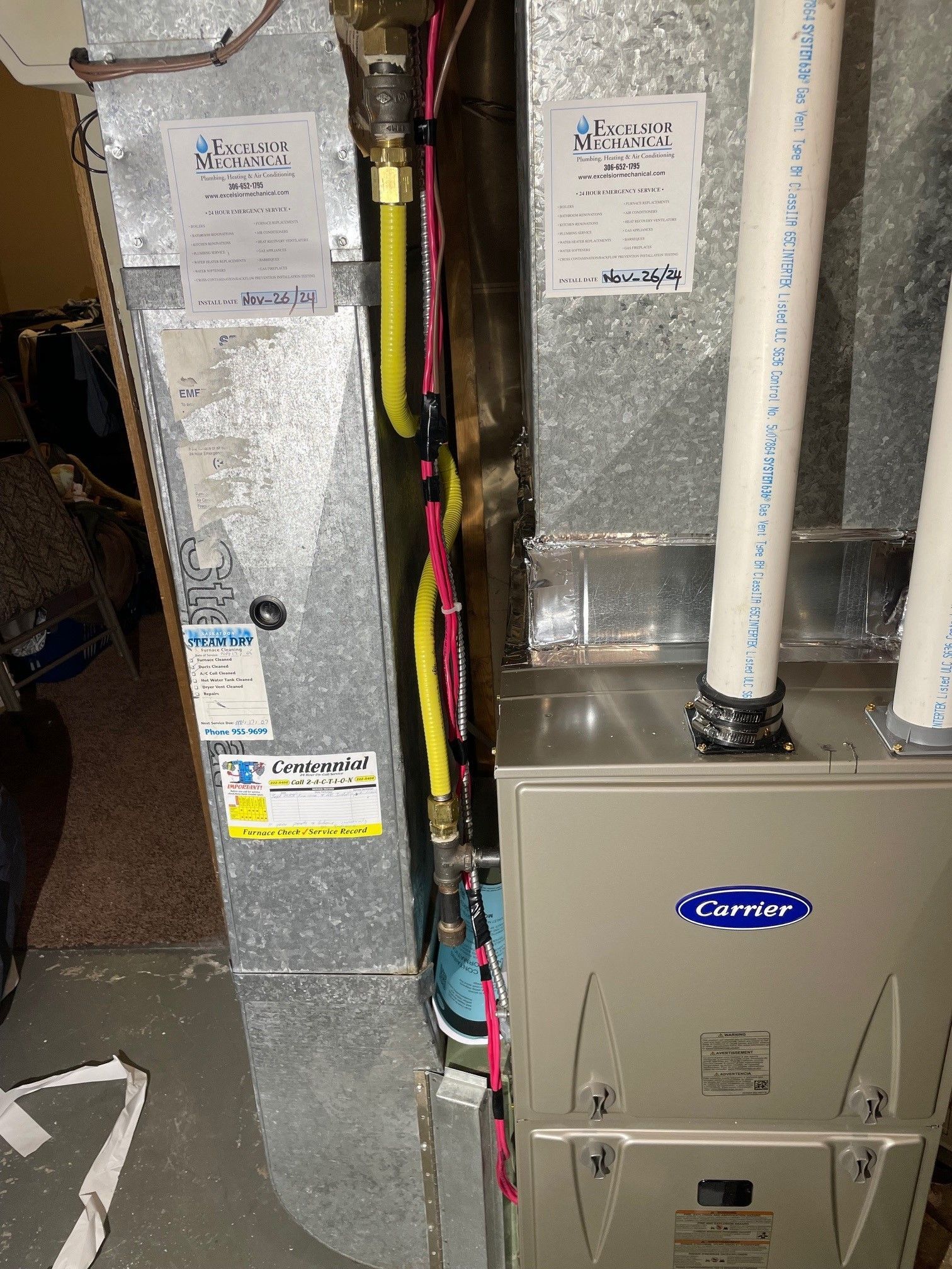 A carrier air conditioner is sitting in the basement of a house.