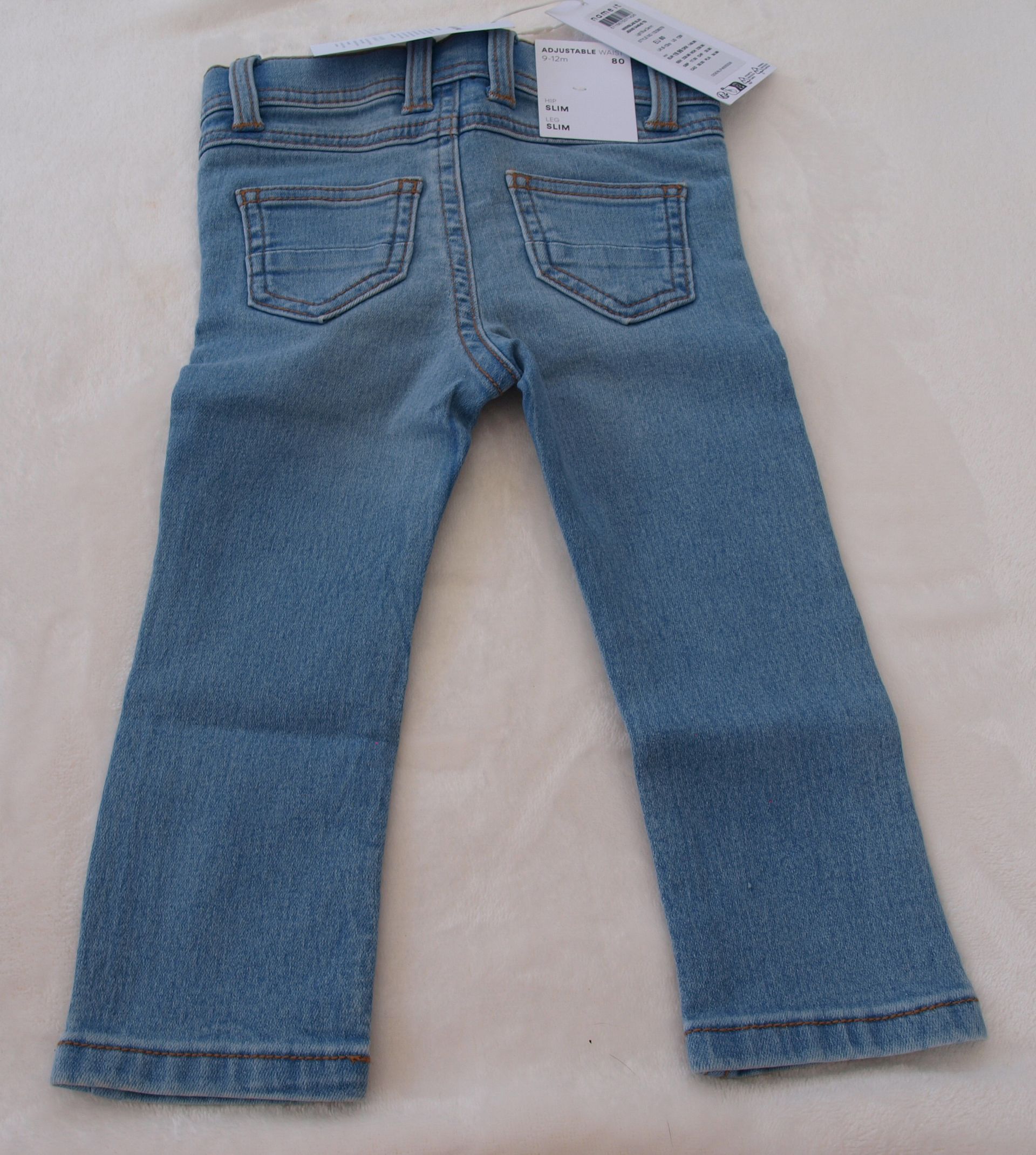 Een lichtblauwe spijkerbroek op een wit oppervlak