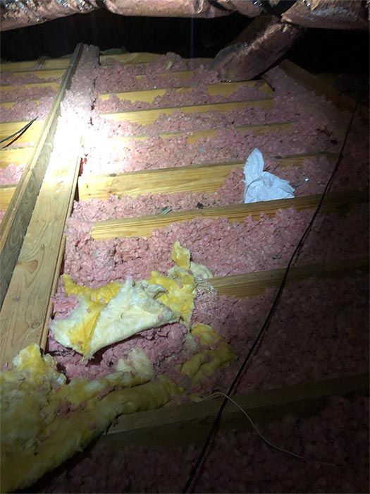 There is a lot of insulation in the attic of a house.