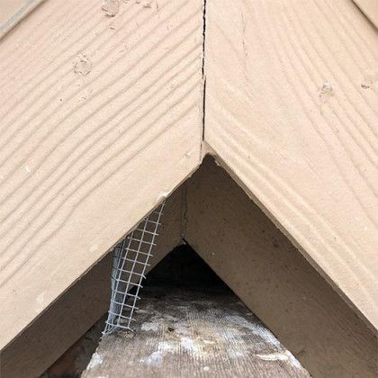 A close up of a piece of wood with a metal mesh on it.