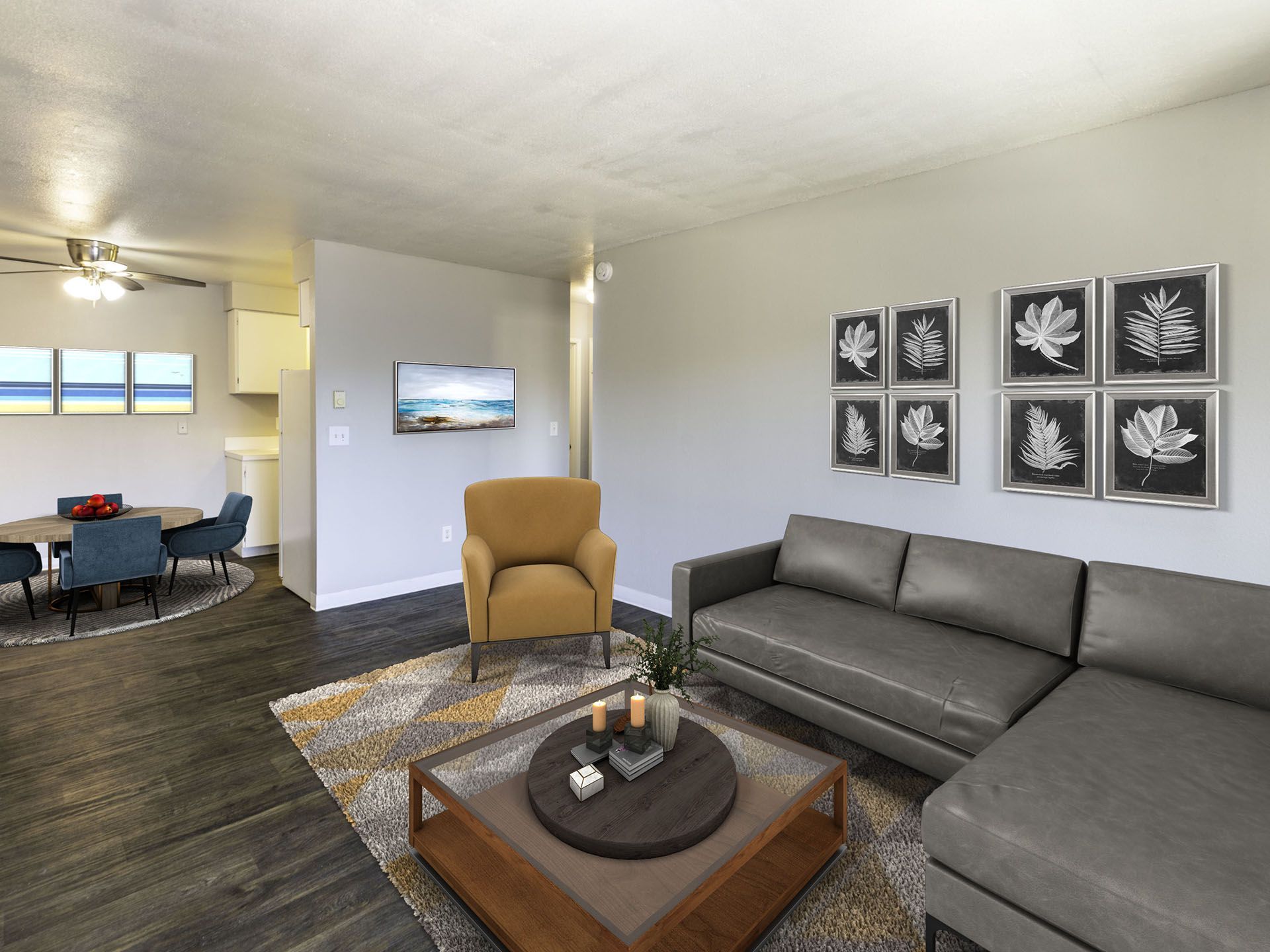 Photo of a living room, showing a dining area and kitchen in the background
