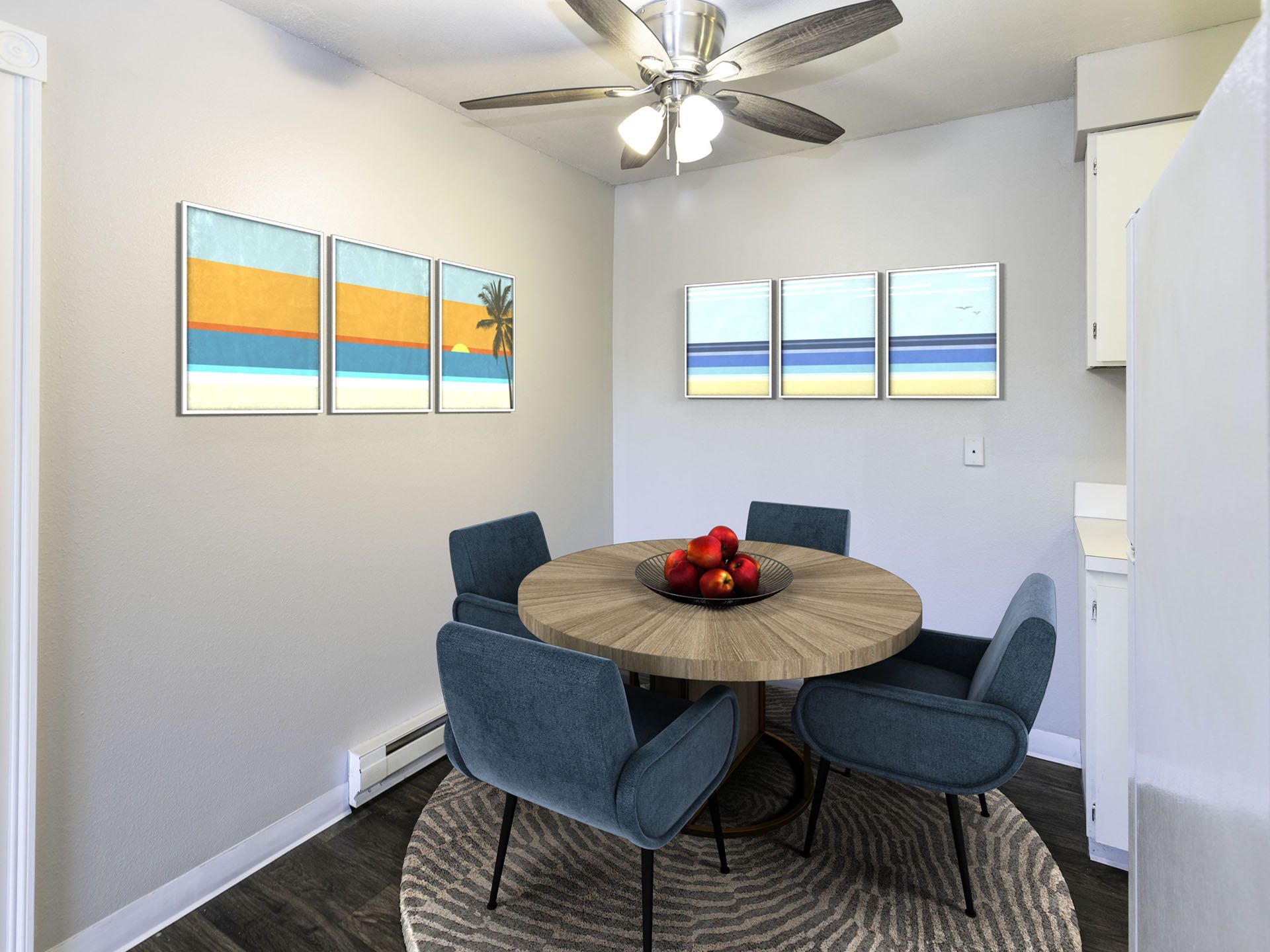 Photo of a dining area with a kitchen at the edge of the photo