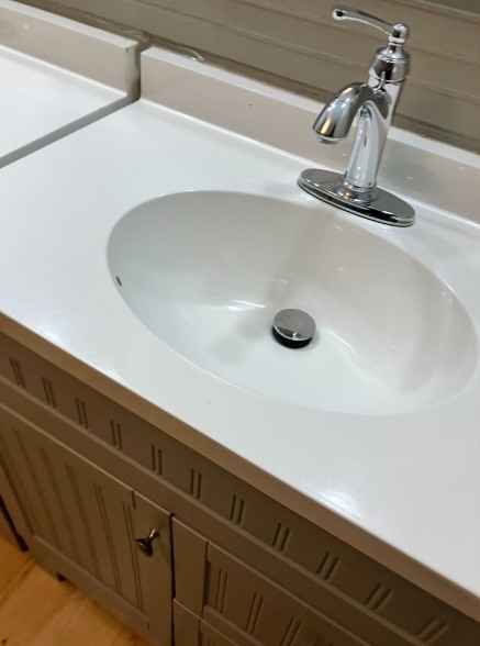 A bathroom sink after best house cleaning services in Boone NC with a chrome faucet and a white counter top