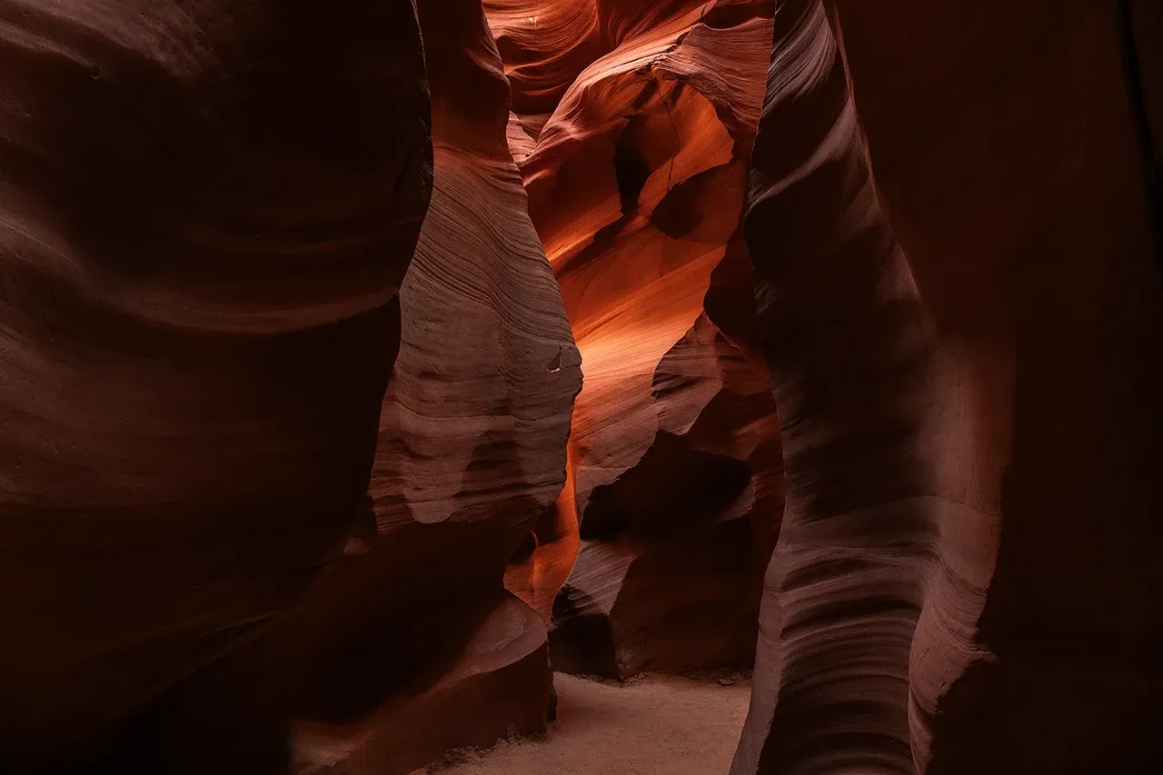Narrow red sandstone canyon with warm light and layered rock walls