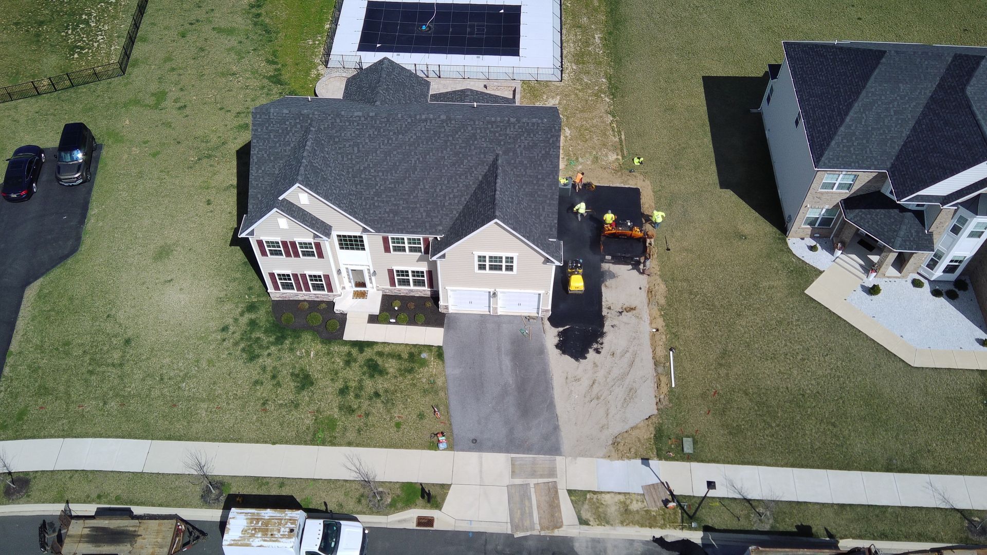 an aerial view of a house being built in a residential neighborhood