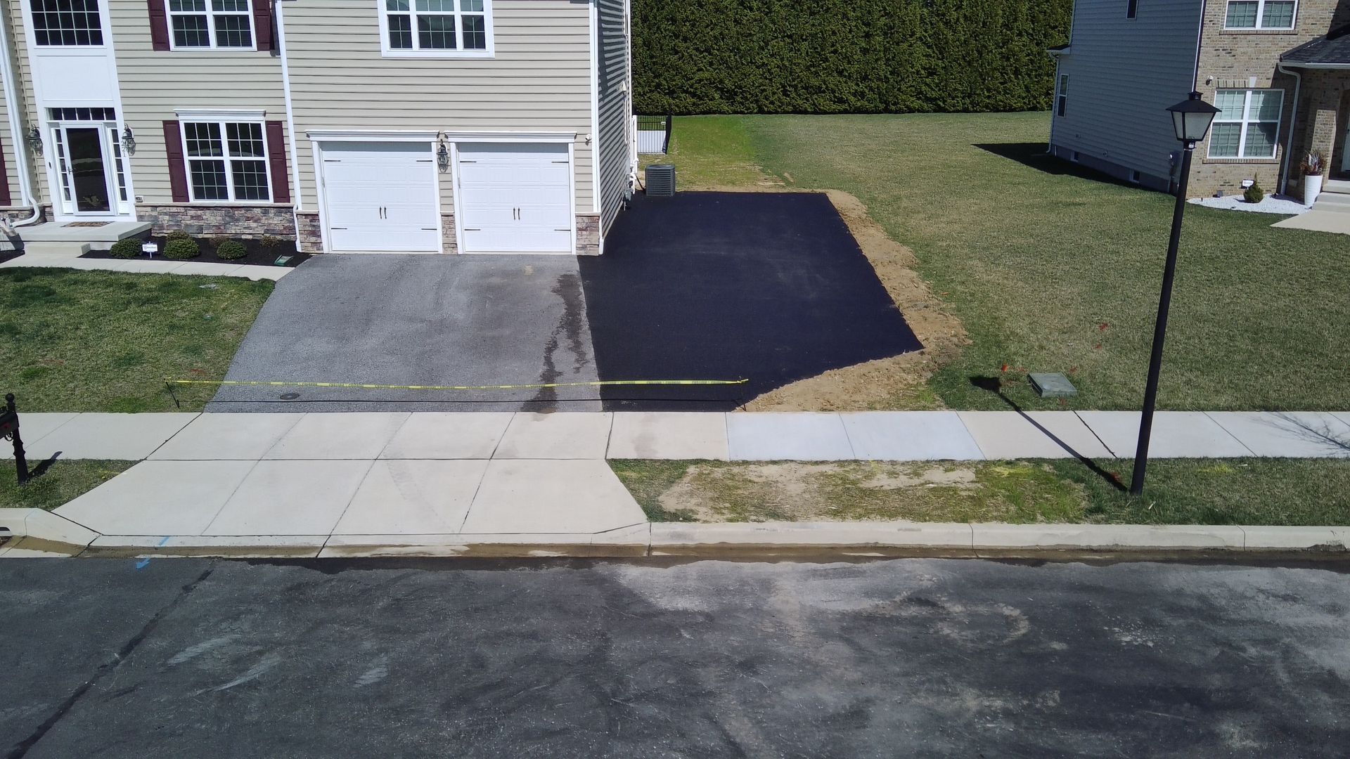 an aerial view of a driveway leading to a house