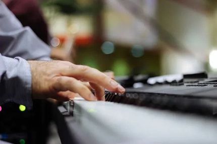 A close up of a person playing a keyboard.