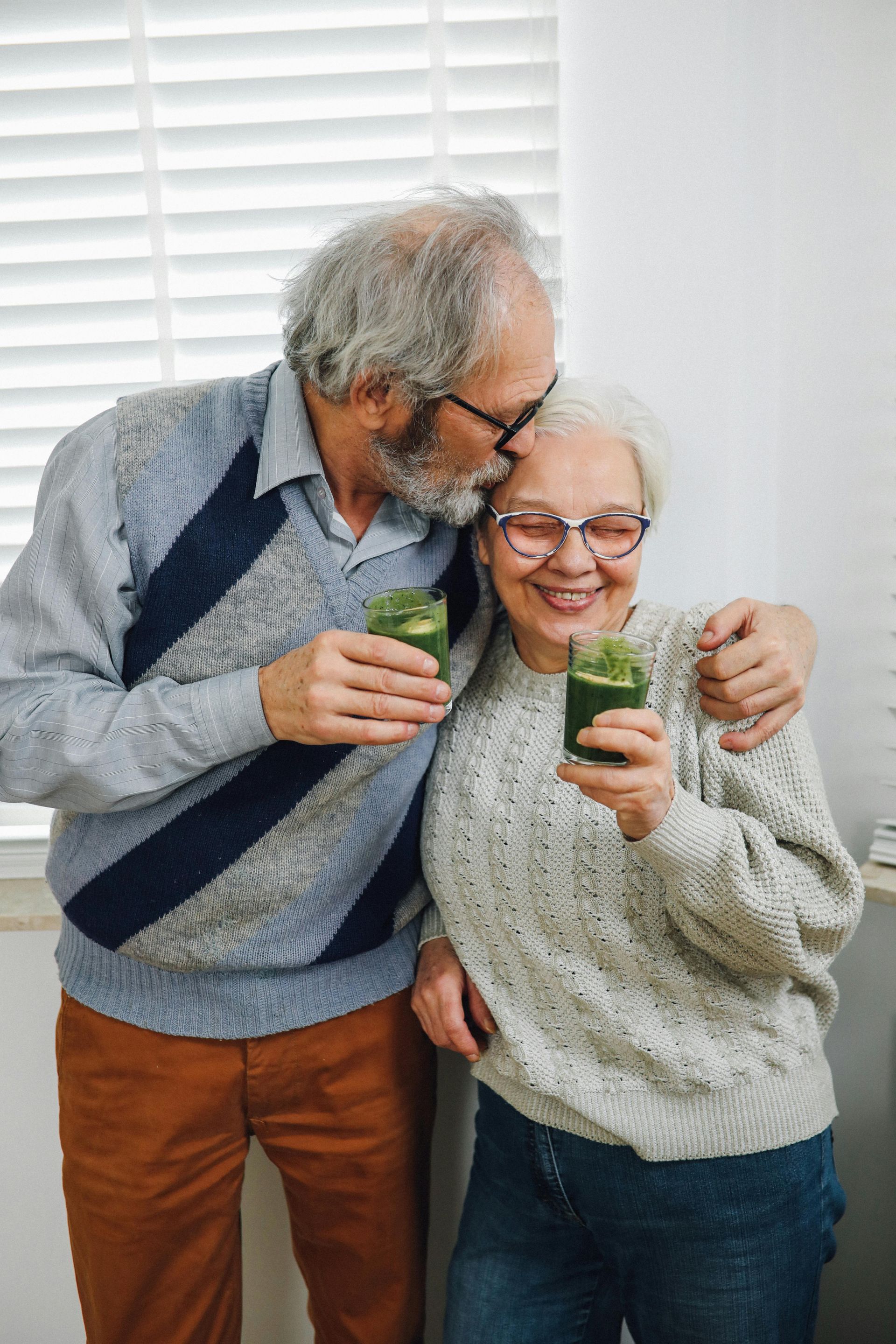 Happy couple drinking green juice together