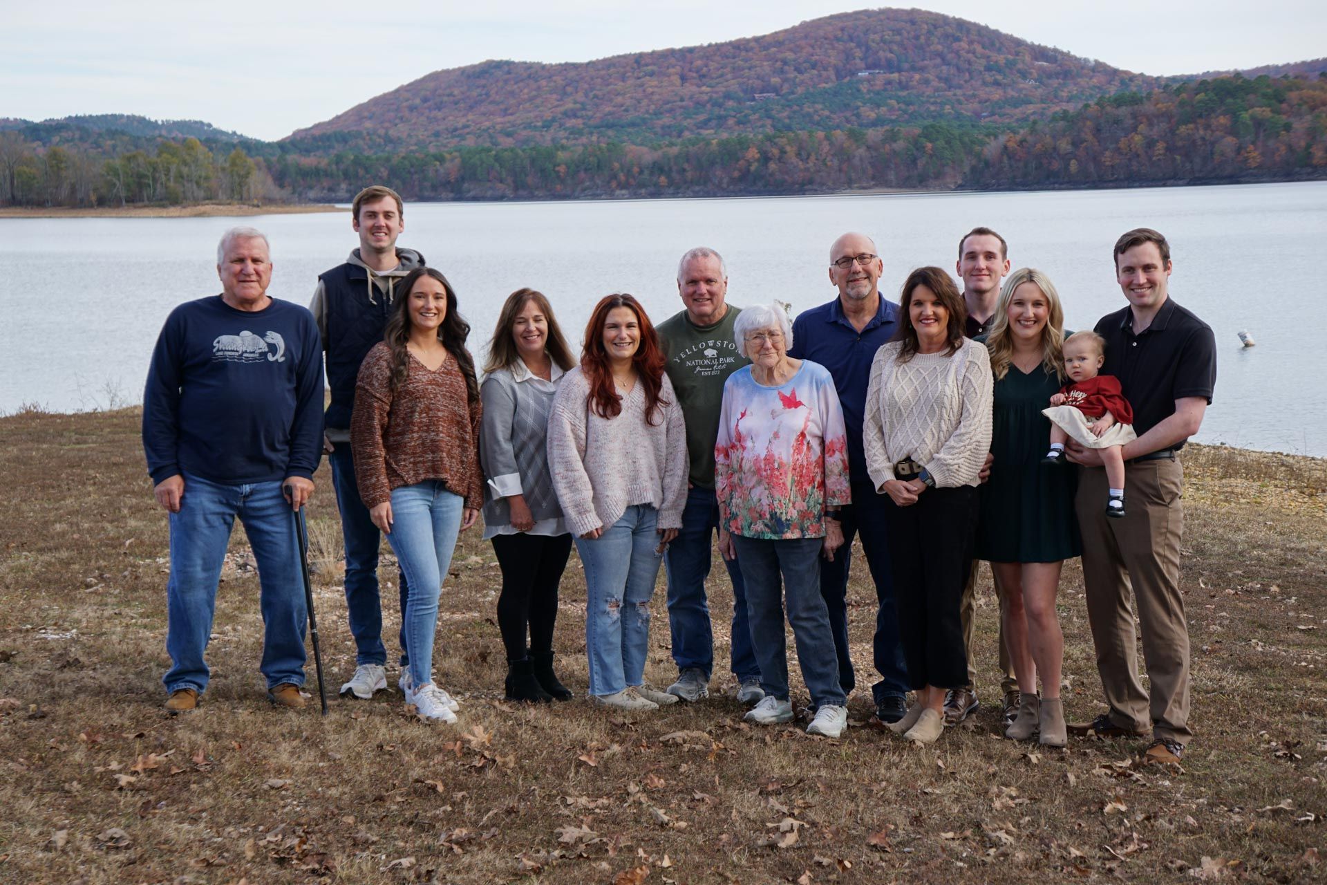 A sunset over a lake with a bird feeder in the foreground.