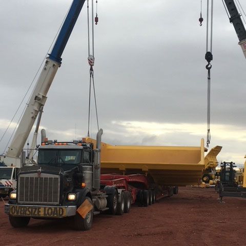 Truck Carrying a Yellow Equipment — Gillette, WY — Black Hawk Crane & Rigging Inc